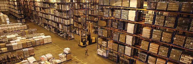 Aisles of racked and palletized cargo filling the SBCFS bonded container freight station
